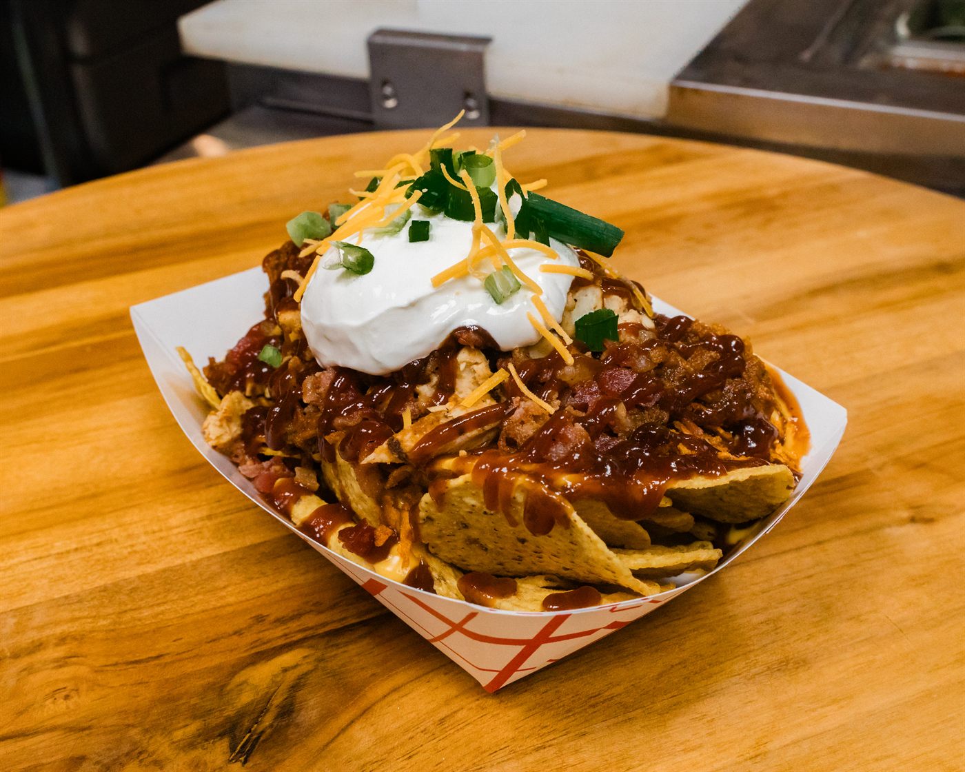 Signature loaded baked potato with sauce, cheese, and sour cream